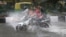 A motorcyclist drives through a water logged street during a heavy downpour in New Delhi, India, July 9, 2023. 