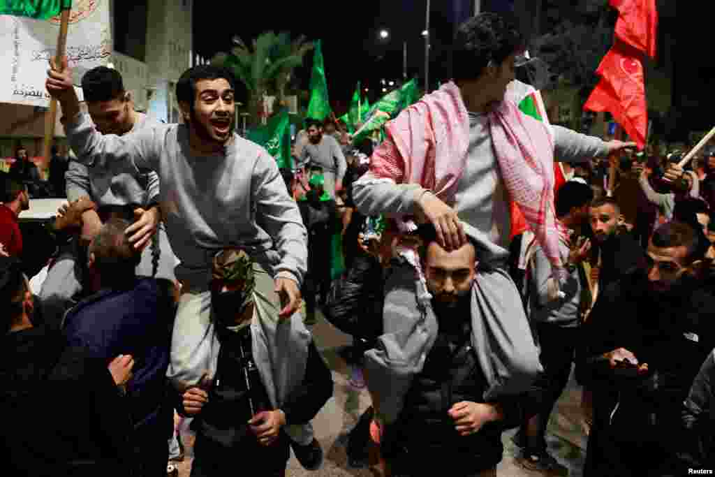 Released Palestinian prisoners react after leaving the Israeli military prison, Ofer, amid a hostages-prisoners swap deal between Hamas and Israel, near Ramallah in the Israeli-occupied West Bank.