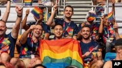 FILE - Participants wave rainbow flags during the opening ceremony of the Gay Games in Hong Kong, Nov. 4, 2023. 