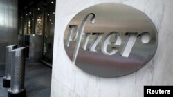 FILE - The Pfizer logo identifies the pharmaceutical company's headquarters in New York, Nov. 9, 2020.