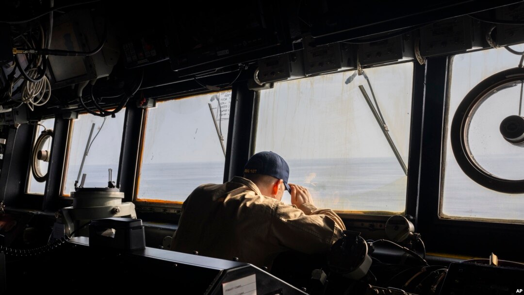 FILE - A crew member observes from the bridge of the USS Gravely destroyer in the south Red Sea, Feb. 13, 2024. Greek-flagged oil tanker traveling through the Red Sea came under repeated attack Wednesday, the British military said.