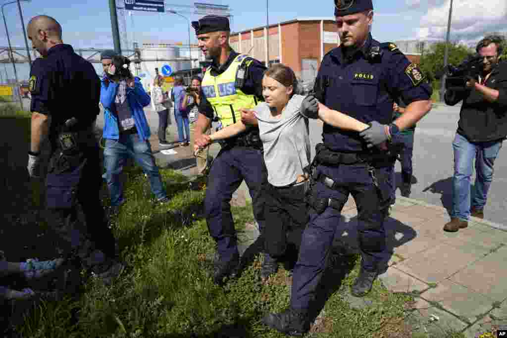 Police detain climate activist Greta Thunberg during a demonstration for blocking the entrance to an oil facility in Malmo, Swede.
