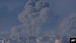 Smoke rises following an Israeli bombardment in the Gaza Strip, as seen from southern Israel , Dec. 6, 2023.