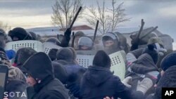 In this photo taken from video released by Russian independent news outlet SOTA telegram channel on Jan. 17, 2024, Russian police clash with protesters in Baymak, Bashkortostan, a region spread between the Volga River and the Ural Mountains, Russia.