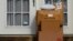 FILE - Packages are seen stacked on the doorstep of a residence, Oct. 27, 2021, in Upper Darby, Pa.