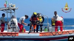 This picture released by the Italian Firefighters, Aug. 23, 2024, shows a firefighter cave diver as he prepares to reach the wrecked luxury superyacht Bayesian that sunk early Monday off the Sicilian coast in Porticciolo, in southern Italy.