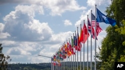 Flags of NATO member countries flap outside the venue of the NATO summit in Vilnius, Lithuania, July 9, 2023. Russia's war on Ukraine will top the agenda when U.S. President Joe Biden and his NATO counterparts meet in Vilnius on Tuesday and Wednesday.