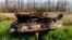 FILE - A scorched car rests in the yard of a home destroyed by a wildfire in the East Prairie Metis Settlement, Alberta, July 4, 2023. 