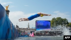 Italy's Alessio Crociani dives into the Seine river to start the swimming stage of the men's individual triathlon at the Paris 2024 Olympic Games in central Paris on July 31, 2024.