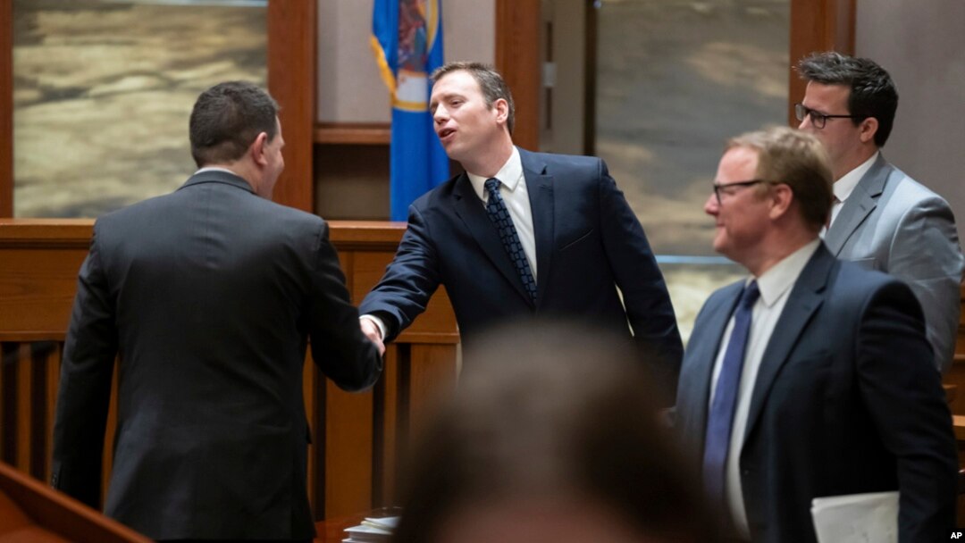 Ronald Fein, attorney for the petitioner, Free Speech for People, left, shakes hands with Donald Trump's attorney Nicholas Nelson, center, after they argued their cases before the Minnesota Supreme Court, Nov. 2, 2023 St. Paul, Minn.