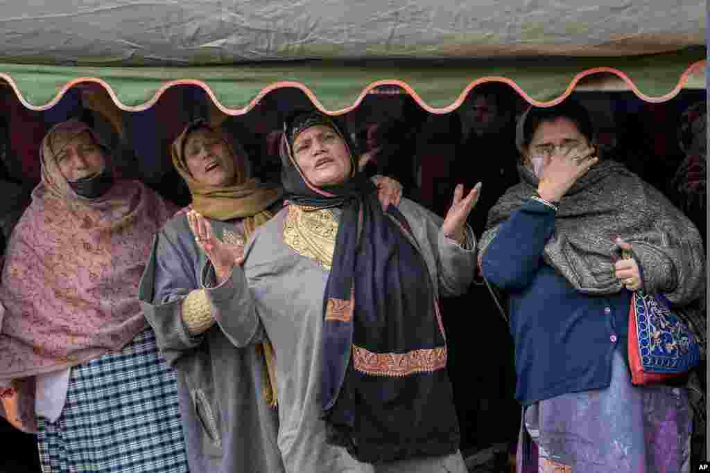 Unidentified relatives wail during the funeral procession of police officer Masroor Ahmad Wani in Srinagar, Indian controlled Kashmir.&nbsp;Wani was wounded when suspected rebels shot at him while he was playing cricket with boys in his neighborhood in October.&nbsp;