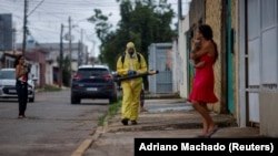 Health workers spray insecticide to kill mosquitos. This is to help slow a dengue outbreak in Brasilia, Brazil, on January 24, 2024. (REUTERS/Adriano Machado)