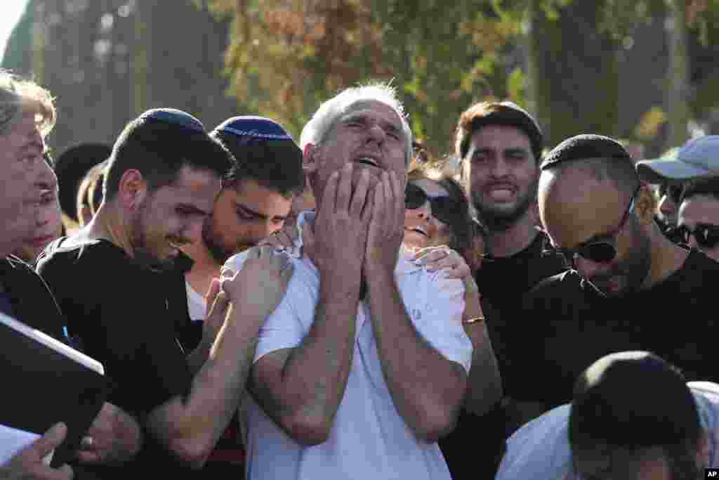 Yigal Sarusi, center, mourns during the funeral of his son, slain hostage Almog Sarusi, who was killed in Hamas captivity in the Gaza Strip, at a cemetery in Ra&#39;anana, Israel.