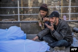 People mourn at al-Shifa hospital in Gaza City over the bodies of Palestinians killed in an early-morning incident when residents rushed toward aid trucks in Gaza City, Feb. 29, 2024.