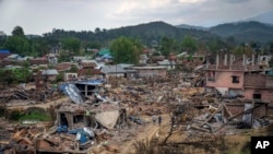 FILE - Dozens of houses lay vandalised and burnt during ethnic clashes and rioting in Sugnu, in the northeastern Indian state of Manipur, June 21, 2023.