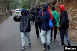 A group of migrants walk towards the Las Raices Camp in La Laguna, Spain, November 4, 2023. (REUTERS/Borja Suarez)