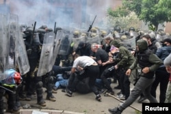 NATO Kosovo Force (KFOR) soldiers clash with local Kosovo Serb protesters at the entrance of the municipality office, in the town of Zvecan, Kosovo, May 29, 2023.