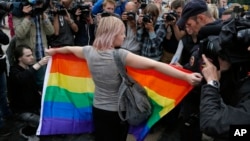 FILE - A gay rights activist protests at Dvortsovaya (Palace) Square in St. Petersburg, Russia, Aug. 2, 2015.