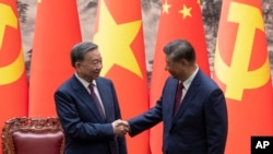 Chinese President Xi Jinping, right, and Vietnam's President To Lam shake hands after a signing ceremony at the Great Hall of the People in Beijing, Aug. 19, 2024. 