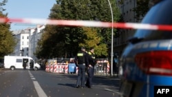 FILE - Policemen stand guard in front of a building housing the synagogue of the Kahal Adass Jisroel Jewish community in Berlin, on Oct. 18, 2023. Police say two Molotov cocktails were thrown at the building, but there were no reports of injuries or damage.