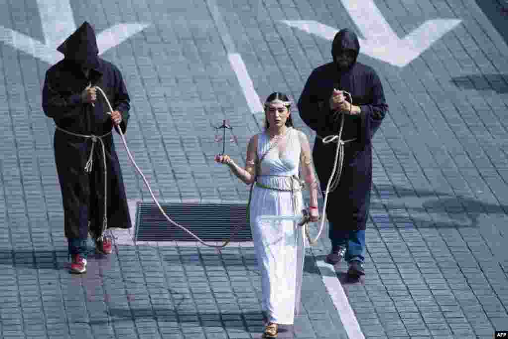 A Judicial Branch employee dressed as "Themis" staged a performance as she took part in a protest against the judicial reform proposed by the government in the streets of Monterrey, Nuevo León State, Mexico, Sept. 1, 2024. 