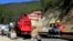 Rescuers rest at the site of an under-construction road tunnel that collapsed in Silkyara in the northern Indian state of Uttarakhand, Nov. 24, 2023. 