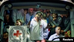 Released Palestinian prisoners react from inside a vehicle after leaving the Israeli military prison, Ofer, amid a hostages-prisoners swap deal between Hamas and Israel, near Ramallah in the Israeli-occupied West Bank, Nov. 26, 2023.