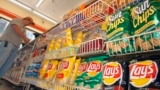 FILE - A customer makes a purchase at a convenience store in Boston in this July 12, 2005 file photo. (AP Photo/Lisa Poole, file)