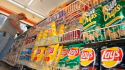 FILE - A customer makes a purchase at a convenience store in Boston in this July 12, 2005 file photo. (AP Photo/Lisa Poole, file)