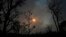 FILE - The sun sets behind the smoke of large-scale fires in the native Cerrado forest at the National Park in Brasilia, Brazil, Sept. 5, 2022.