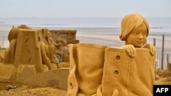A sand sculpture representing figures in fairy tales is ready prior to the start of the Sand Sculpture Festival, in Middelkerke, Belgium.