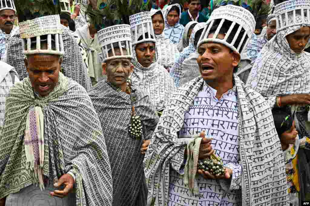 Members of the Ramnami religious movement take part in the Bhajan mela - an annual festival of the sect - near the Mahanadi river at Jaijaipur in Chhattisgarh, India.