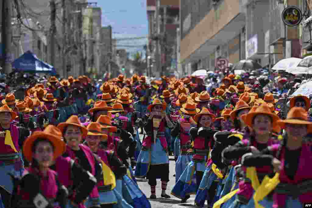 Revelers take part in the "Chant to the Earth" parade during the Carnival of Blacks and Whites in Pasto, Colombia, Jan. 3, 2024. 