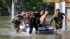 Police evacuate local residents from a flooded area after the Nova Kakhovka dam breached, amid Russia's attack on Ukraine, in Kherson, Ukraine, June 7, 2023. 