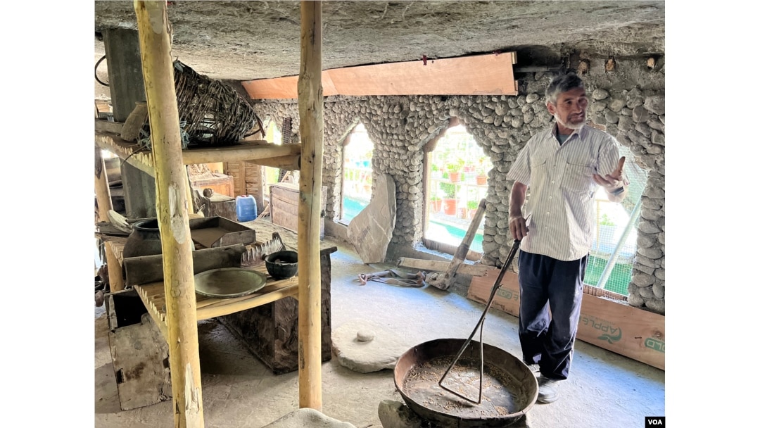 A resident of Turtuk, Mohammed Ali Bari, shows his museum to visitors in Turtuk. (Bilal Hussain/VOA)