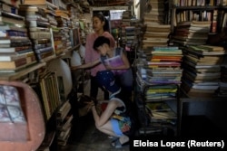 Children look at the books at Guanlao's home library in Makati, a metro area of Manila, Philippines, February 7, 2024. (REUTERS/Eloisa Lopez)