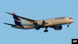 FILE - A LATAM Airlines Boeing 787 approaches for landing in Lisbon at sunrise, July 5, 2023. 