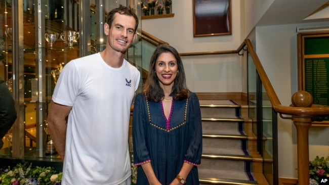 Nazanin Zaghari-Ratcliffe poses for a photo with Britain's Andy Murray in the clubhouse after his first round men's singles match at the Wimbledon tennis championships in London, July 4, 2023.