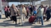 Warga Palestina yang memiliki dwikewarganegaraan, berjalan di Rafah, Jalur Gaza selatan yang berbatasan dengan Mesir, dengan harapan mendapatkan izin meninggalkan Gaza, di tengah konflik Israel-Hamas, 1 November 2023. (REUTERS/Arafat Barbakh)