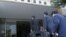 FILE - Officials from the Tokyo District Public Prosecutors Office enter a building to search the office of Shisuikai, a faction of the Liberal Democratic Party (LDP), in Tokyo on Dec. 19, 2023.