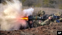 FILE - A Ukrainian serviceman fires an NLAW anti-tank weapon during exercises ahead of Russia's full-scale invasion, in Ukraine's eastern Donetsk region, Feb. 15, 2022. 