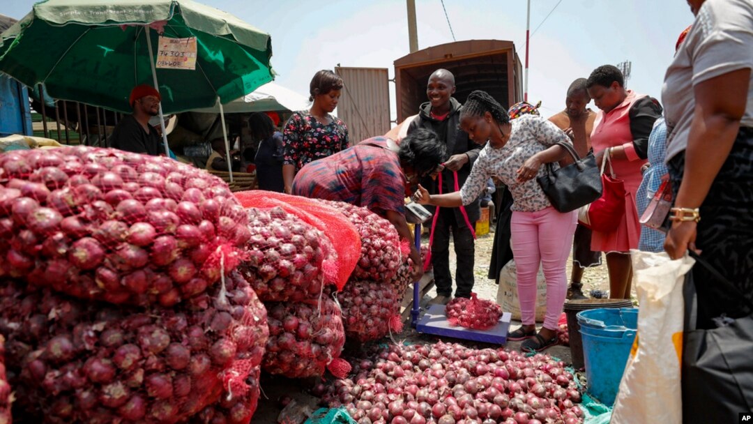 FILE - People buy onions at an open market in Nairobi, Kenya, Sept. 12, 2023. The African Union and the International Livestock Research Institute are designing guidelines to help African governments improve food safety in informal food markets.
