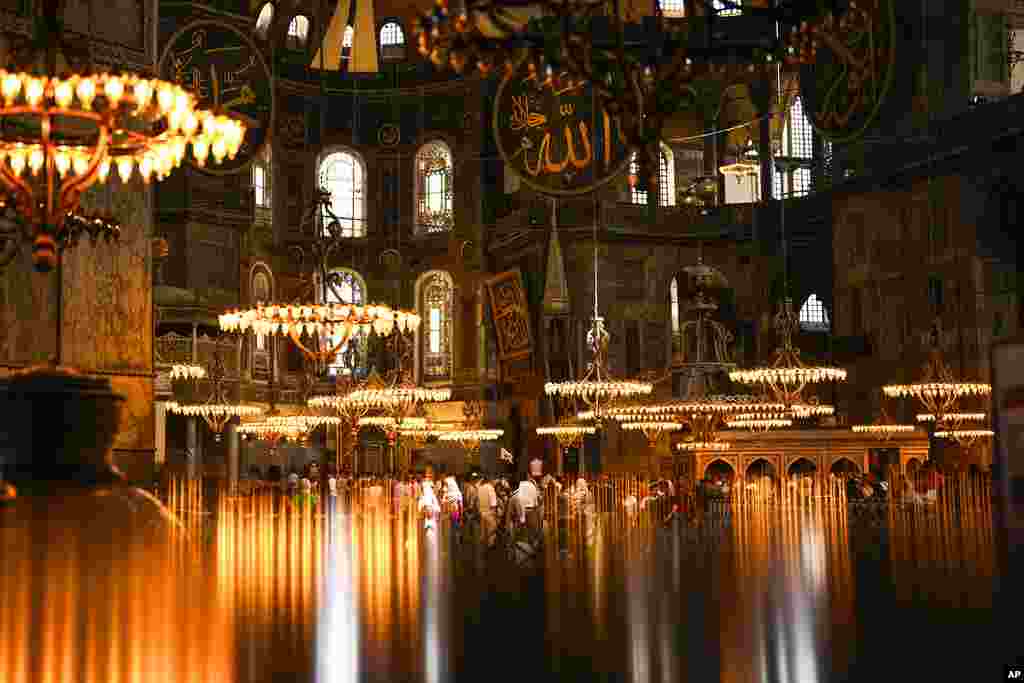 Tourists and locals visit Byzantine-era Hagia Sophia mosque in Istanbul, Turkey.