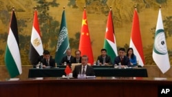 Chinese Foreign Minister Wang Yi, center, delivers his speech during a round table meeting with five Arab and Islamic counterparts at the Diaoyutai state guesthouse in Beijing, Nov. 20, 2023. 