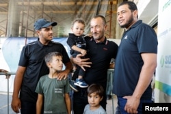 The brother and sons of Qaid Farhan Alkadi, a Bedouin Israeli hostage who was kidnapped during the deadly October 7 attack, pose after Alkadi was rescued by Israeli forces, at Soroka Medical Center in Beersheba, Israel, Aug. 27, 2024.