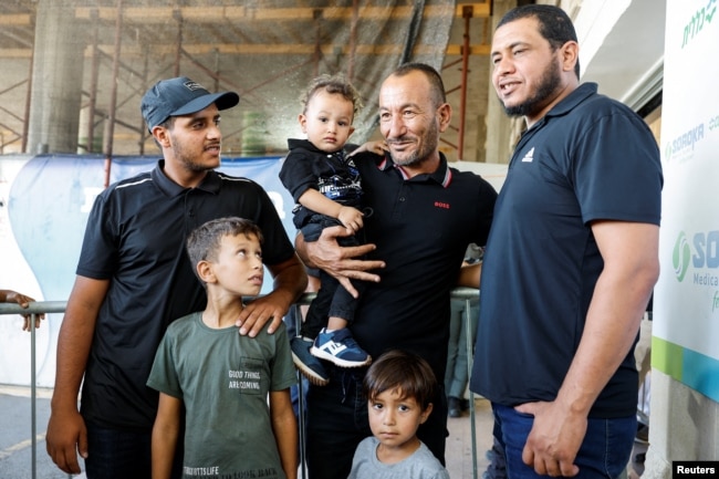 The brother and sons of Qaid Farhan Alkadi, a Bedouin Israeli hostage who was kidnapped during the deadly October 7 attack, pose after Alkadi was rescued by Israeli forces, at Soroka Medical Center in Beersheba, Israel, Aug. 27, 2024.