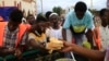 FILE - Sudanese displaced from the town of Sinjah queue to receive food at their makeshift camp in the eastern city of Gedaref, Sudan, Aug. 22, 2024. 