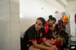 Women players of ASFAR soccer team take a half-time break during a match against ASDCT Ain Atiq, in Morocco's professional women league, in Rabat, Morocco, Wednesday, May 17, 2023. (AP Photo/Mosa'ab Elshamy)