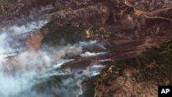 This image provided by Maxar Technologies, shows wildfires on the island of Corfu, Greece, July 25, 2023.