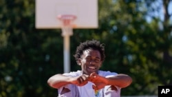 Bryant West poses for a portrait on a basketball court built by NBA star Devin Booker, who went to high school here, in Moss Point, Miss., Friday, Oct. 20, 2023. (AP Photo/Gerald Herbert)